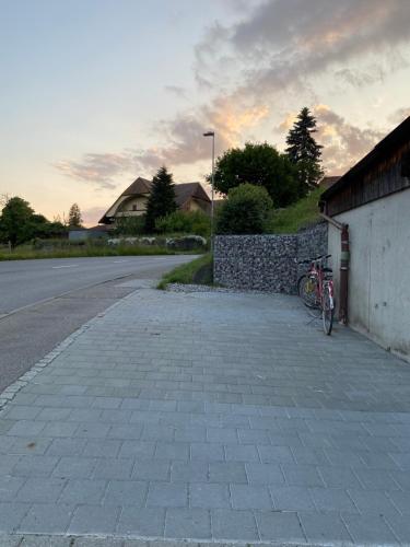 a bike parked on the side of a street at Naturnahe Familienwohnung in Rüschegg-Graben