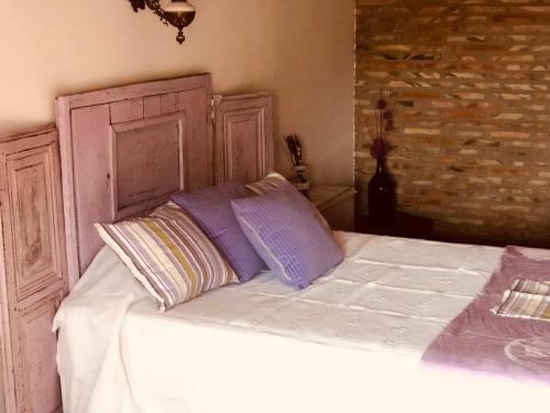 a bed with two pillows on top of it at Las maletas del pasiego in Quintana