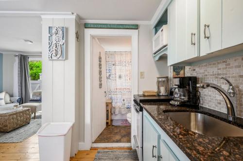 a kitchen with a sink and a living room at 200 Captain Chase Road Dennis Port Cape Cod - - Beach Retreat II in Dennis Port