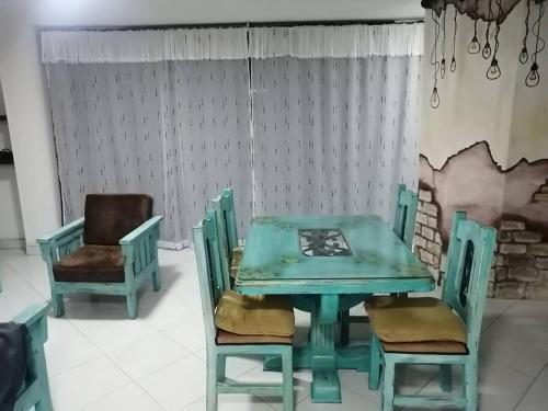 una mesa de comedor verde y 2 sillas en Apartamento cerca al estadio en Medellín 202-1, en Medellín