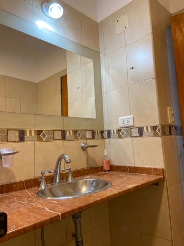 a bathroom with a sink and a mirror at Casa Mía in Resistencia