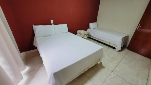 Ένα ή περισσότερα κρεβάτια σε δωμάτιο στο Apartamento aparecida Rone 1