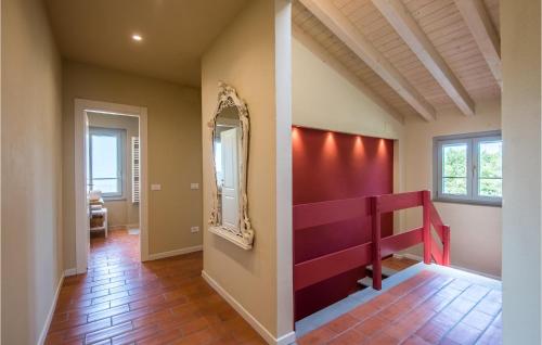 a hallway with a mirror and a red staircase at Casa Le Ginestre in Starda