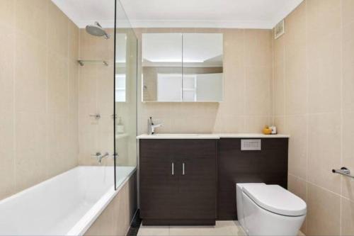 a bathroom with a toilet and a sink and a shower at SeaDreams Beachfront Manly in Manly 