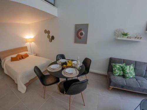 - une chambre avec un lit, une table et des chaises dans l'établissement SP Central Loft, à Vólos