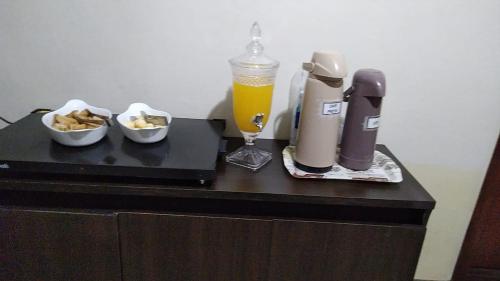 a black table with a drink and snacks on it at HOTEL SÃO LUÍS in Uruguaiana
