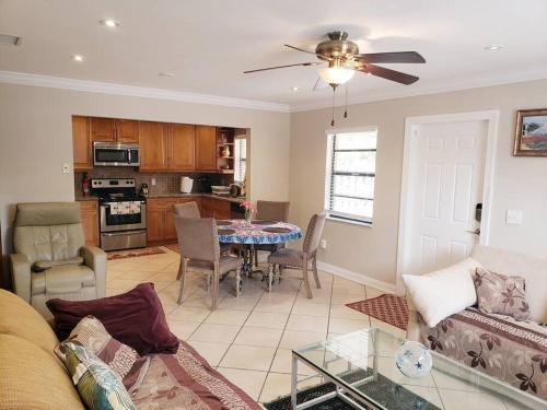 a living room with a couch and a table at OCEAN VACATION BREEZE in Lantana