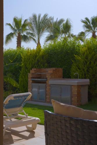 avisor shot of a lawn chair and a lounge chair sidx sidx sidx at Safty Palm Oasis Private Pool & Beach Access in Ain Sokhna