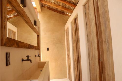 a bathroom with a sink and a mirror at Secret Beach Hostel in Puerto Escondido