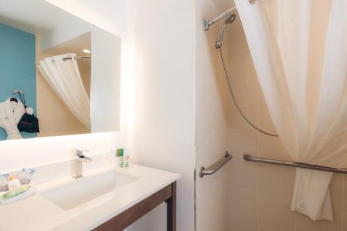 a bathroom with a sink and a shower at The Cove Hotel in Long Beach