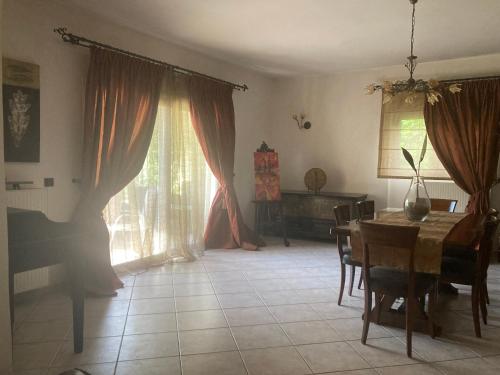 a living room with a table and a piano at VILLA MARIA in Kanálion