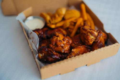 a box of food with chicken and french fries at The Cove Hotel in Long Beach