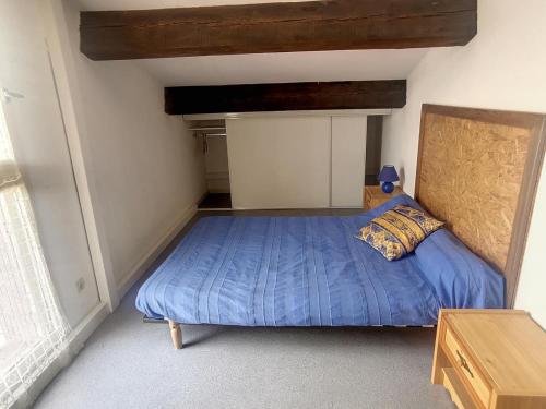 a bedroom with a bed with a blue comforter at Maison Argelès-sur-Mer, 3 pièces, 5 personnes - FR-1-732-45 in Argelès-sur-Mer