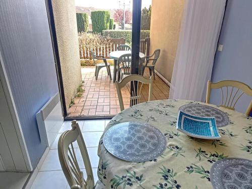 une table et des chaises sur un balcon avec une table et des chaises dans l'établissement Pavillon confortable à 10 min de la mer avec terrasse, parking et local à vélo - FR-1-732-48, à Argelès-sur-Mer