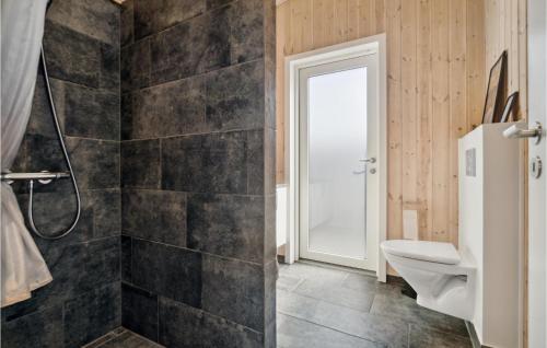 a bathroom with a shower and a toilet at Cozy Home In Nex With Kitchen in Snogebæk
