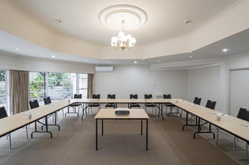 a large room with tables and chairs and a chandelier at Northridge Golf Resort in Orewa