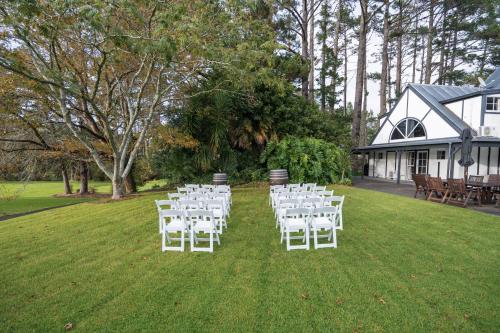 a group of white chairs on a lawn at Northridge Golf Resort in Orewa
