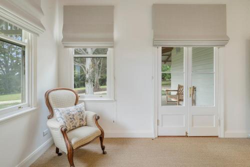a chair in a room with windows and a door at Mansfield Manor in Barwite