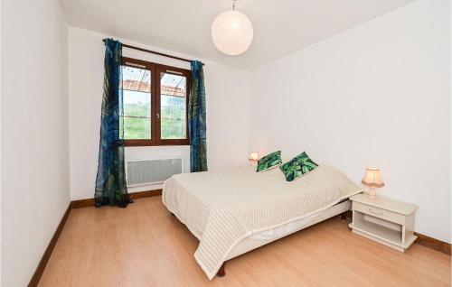 a white bedroom with a bed and a window at Stunning Home In Briare With Outdoor Swimming Pool, Wifi And Sauna in Briare