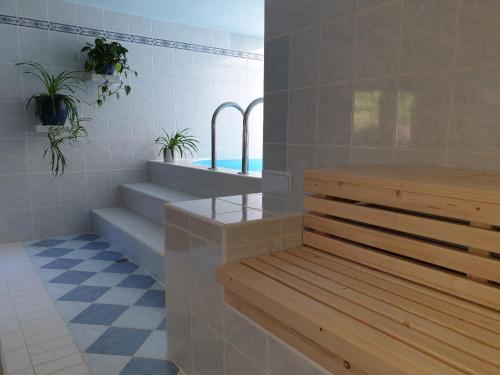 a bathroom with stairs and a bench and plants at chalupa Pod Metodkou in Věcov