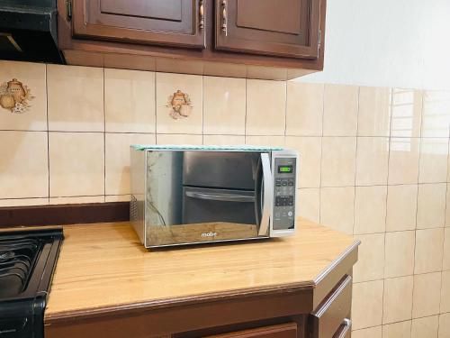 a microwave sitting on a counter in a kitchen at Casa Baraka, Casa Vacacional en Mazatlán cerca de Malecón, Centro Histórico y Playa in Mazatlán