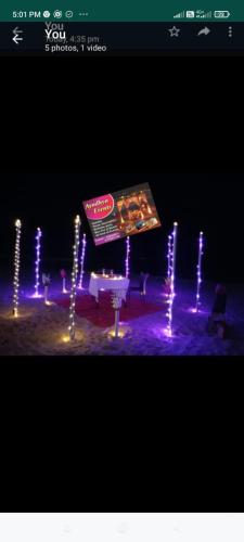 a sign in the middle of a stage with lights at Holiday Tourisms Group of Homestay Rooms Scuba Diving Boating Watersports-Tarkarli-Devbag Beach in Bhogwe