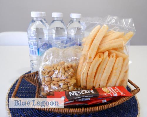 a basket of food with chips and bottles of water at Roxy Sematan Townhouse - Blue Lagoon in Sematan