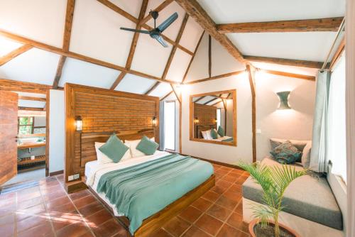 a bedroom with a large bed and a mirror at Coconut Garden Resort in Gili Trawangan