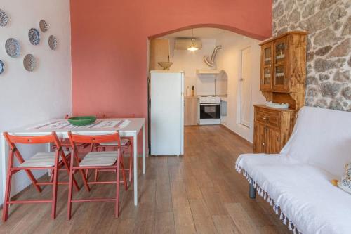 a kitchen with a table and chairs and a white refrigerator at Annas Horizon in Samothraki