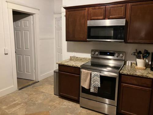 a kitchen with a stove and a microwave at Haven in Downtown in Ogden