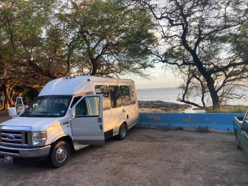 a white van parked next to the beach at Oahu Camper Adventures in Kailua