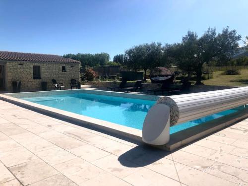 a swimming pool in front of a house at Le Soustet in Malaucène