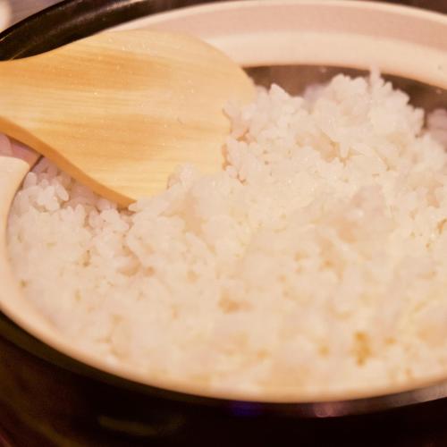 a pot of rice with a wooden spoon in it at 長浜城下 町屋ホテル 和乃リトリートひといき in Nagahama