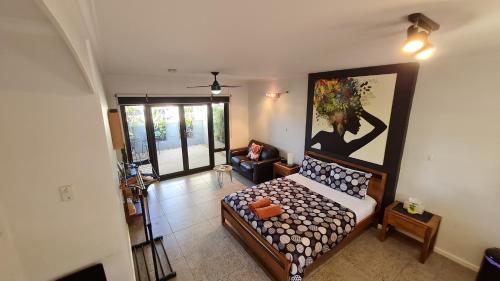 a living room with a bed and a painting on the wall at The Courtyard - Garden View Studio in Port Pirie
