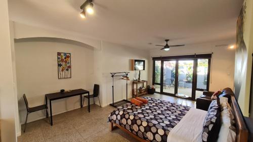 a bedroom with a bed and a desk in it at The Courtyard - Garden View Studio in Port Pirie