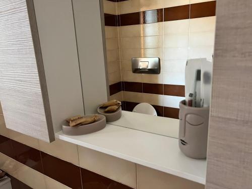 a bathroom with a counter with a dispenser on it at La Perla Marina House in Chiavari