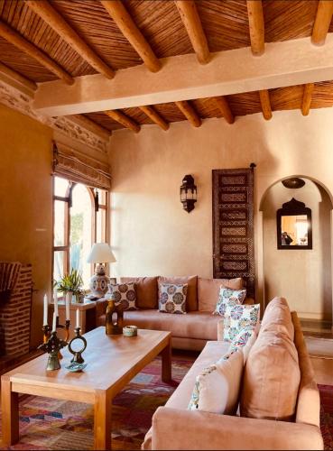 a living room with a couch and a table at Villa des Hauts Mogador in Essaouira
