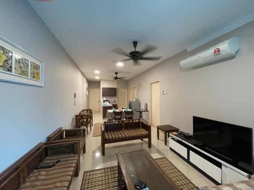 a living room with a ceiling fan and a television at Harmoni Homes Vista Alam in Shah Alam