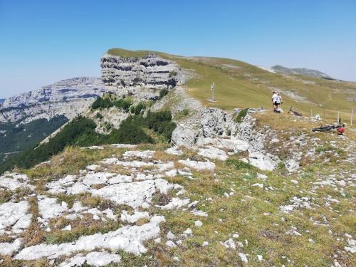 a man standing on top of a rocky mountain at Logement standing wifi Vercors 'In in Saint-Jean-en-Royans