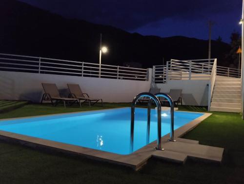 a swimming pool in front of a cruise ship at night at P3 Paradise Apartment Blue Horizon in Anóyia