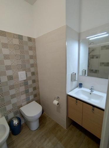 a bathroom with a white toilet and a sink at Panta Rei in Lamezia Terme