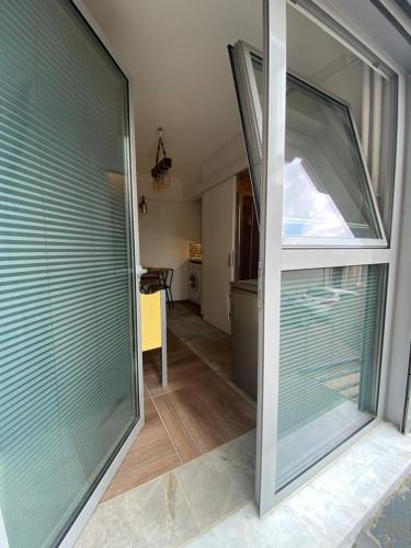 a large glass door to a room with a kitchen at Besiktask Beşiktaş İstanbul in Istanbul