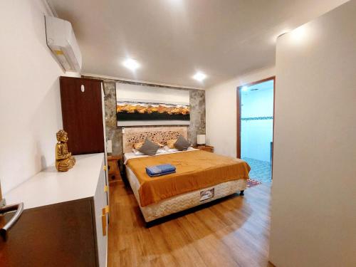 a bedroom with a king sized bed in a room at Happiness Villa 1BR+Private Pool @Seminyak in Seminyak