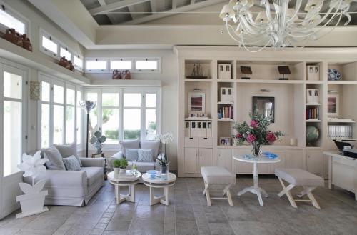 a living room with a couch and a table at Skopelos Village Hotel in Skopelos Town