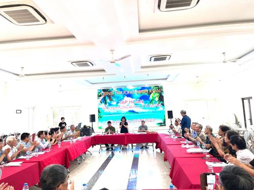 a group of people sitting at tables in a room with a stage at Khách sạn NHẬT MINH Cửa Lò in Cửa Lò