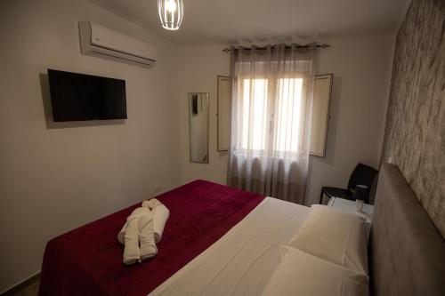 a hotel room with a bed with towels on it at Panta Rei in Lamezia Terme
