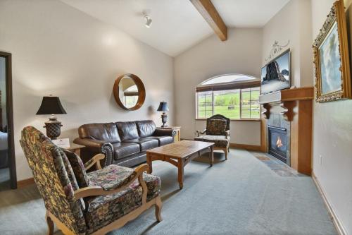 a living room with a leather couch and a table at Adventure Hub-Ski Resorts, Backcountry & Park City 3011 villa in Midway