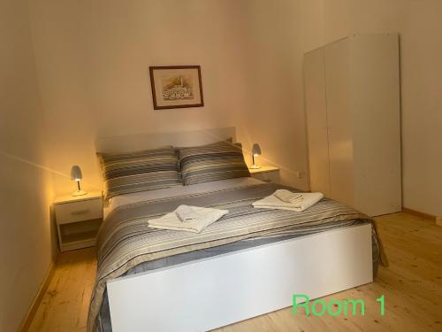 a bedroom with a bed with two towels on it at Boutique House Djak in Rovinj