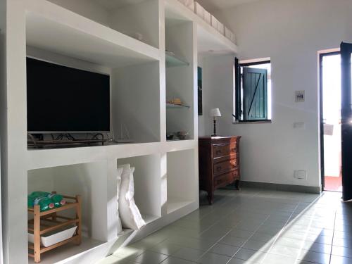 a living room with a flat screen tv on a wall at Casa Mamma Bruna in San Vito lo Capo