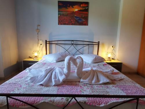 a bedroom with a bed with two swans on it at IRIS STUDIOS in Agios Nikitas